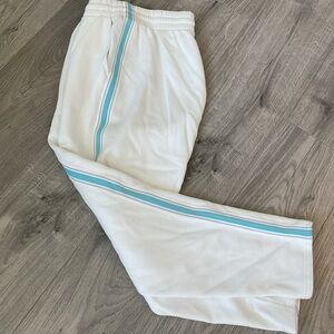 TNA White Cozy Sweatpants with Blue & Brown side stripes.
